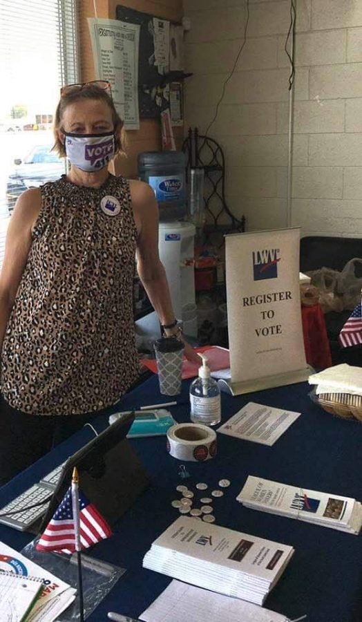Judy Bradford registering people to vote and giving out voting information.