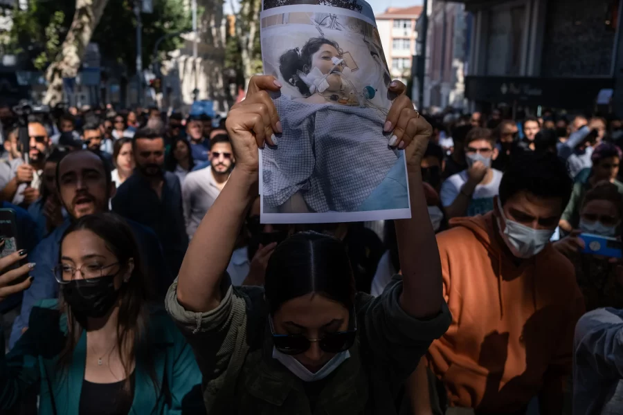 Seen above are protestors holding a picture of Mahsa Amini before she died. 
Image credit - Ashkan Shabani